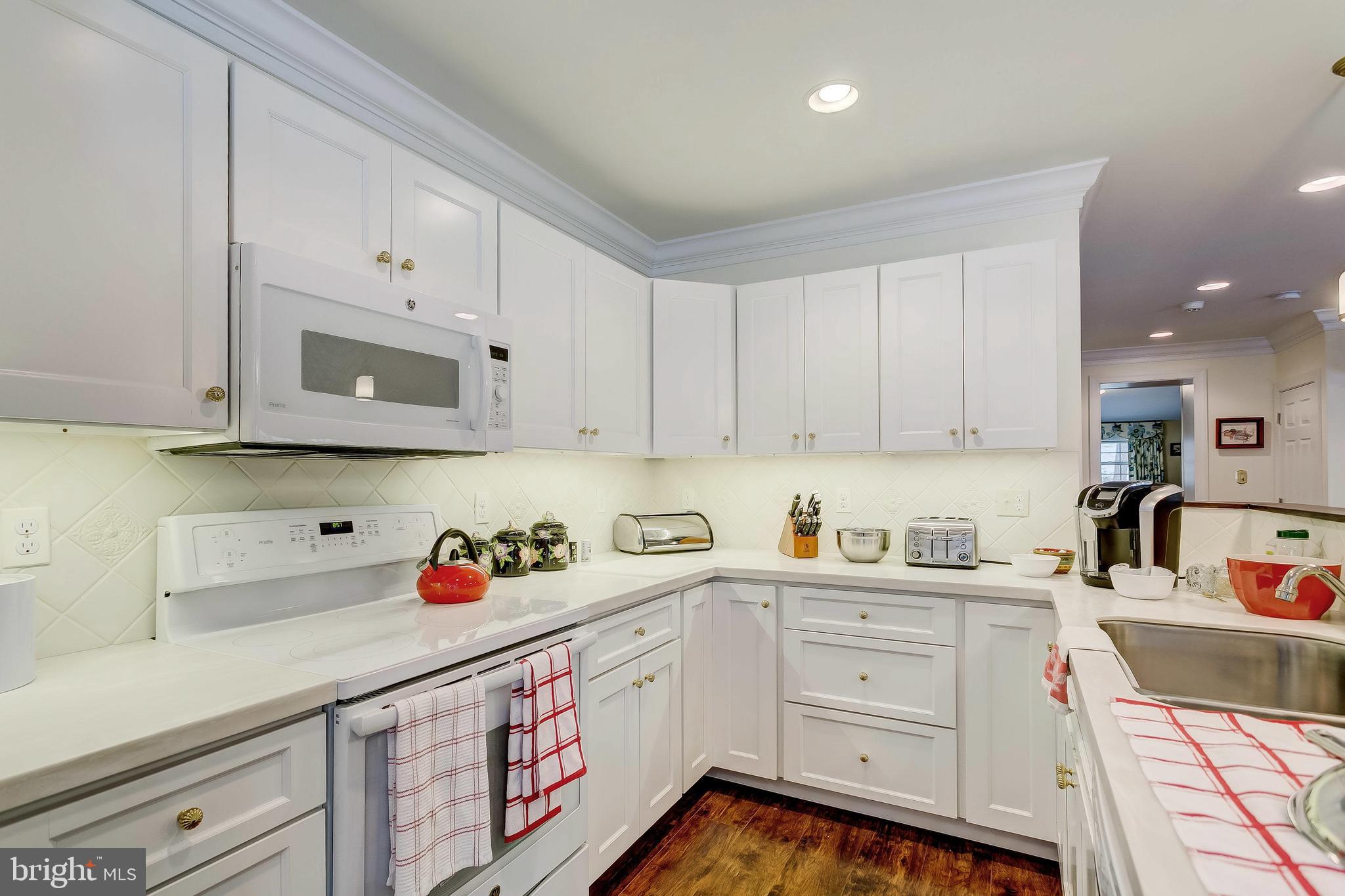 2909 A Butler Road Reisterstown, MD 21136 - Photo 16 of 28 a kitchen with white cabinets sink and white appliances