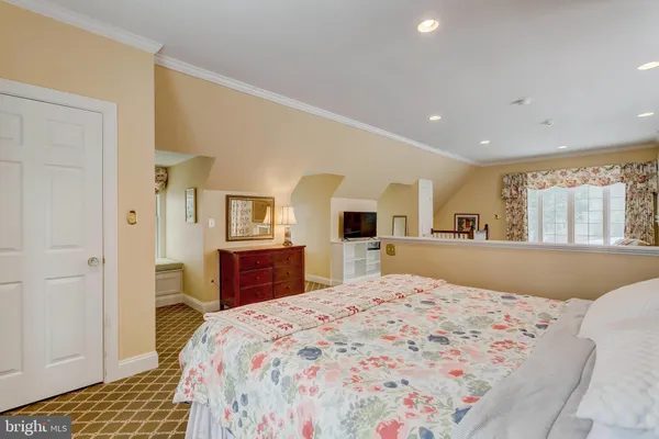 a bedroom with a large bed and dresser