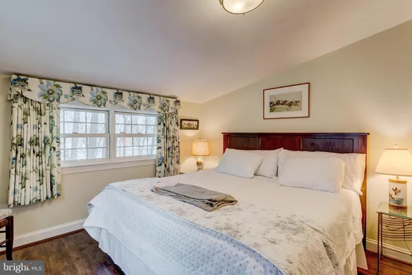 a bedroom with a large bed and a window