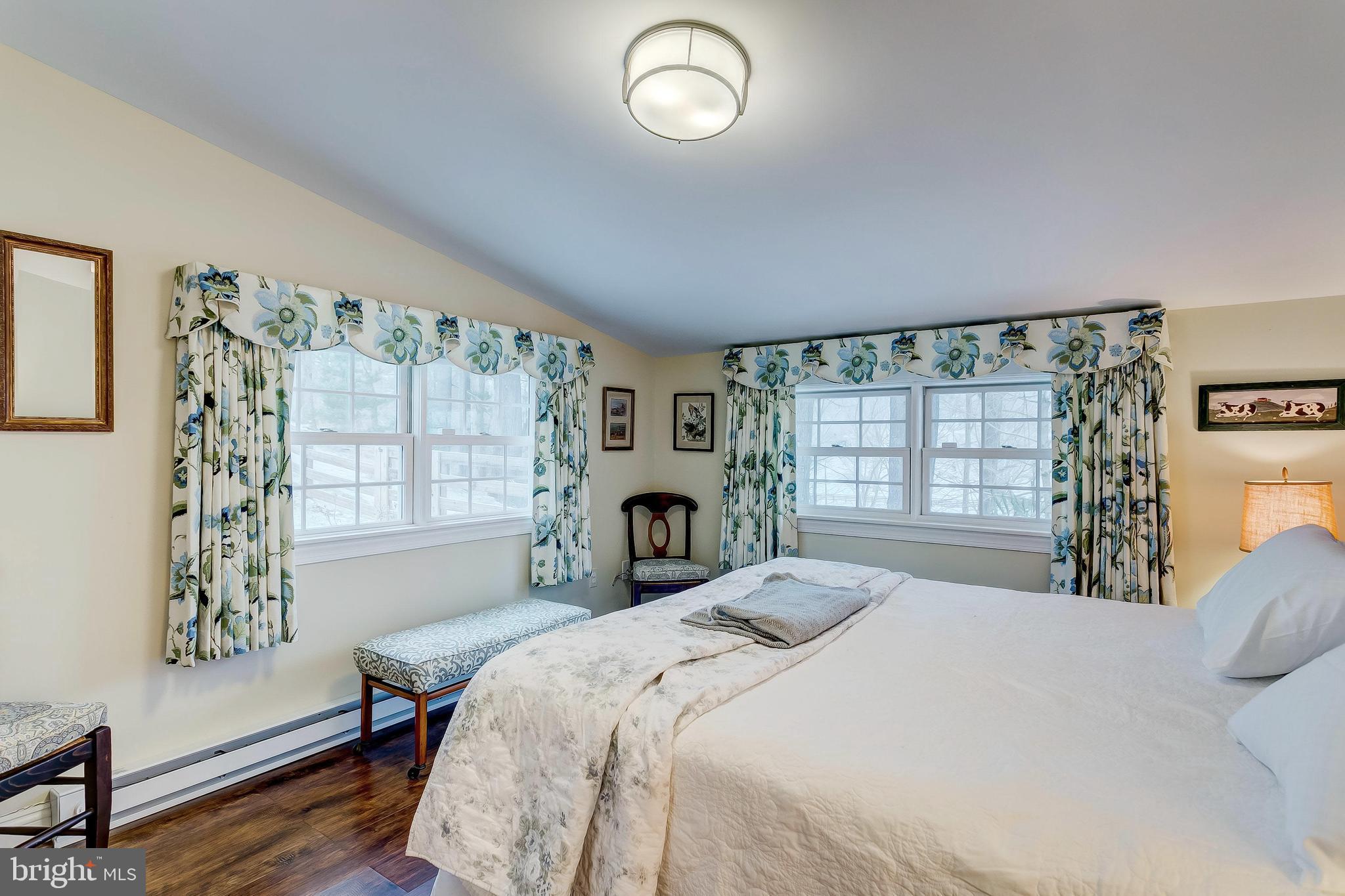 2909 A Butler Road Reisterstown, MD 21136 - Photo 22 of 28 a bed sitting in a bedroom next to a window
