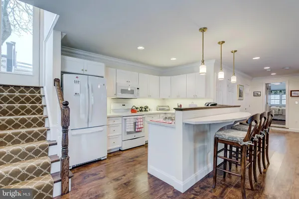 a kitchen with a refrigerator a sink and a oven
