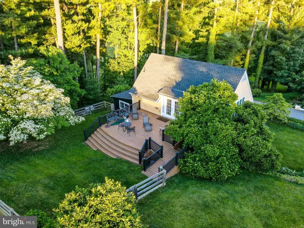 an aerial view of a house with garden space and street view