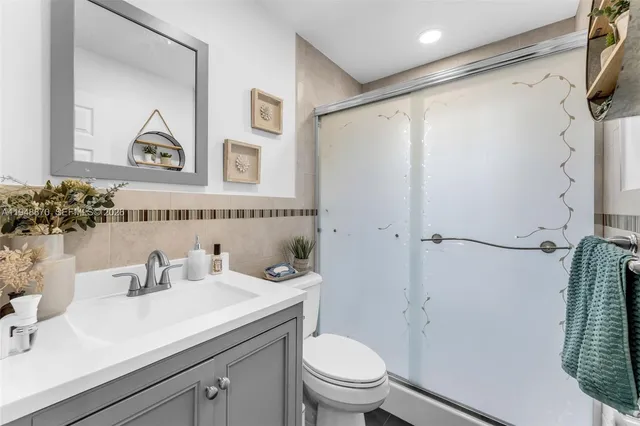 a bathroom with a sink toilet and shower