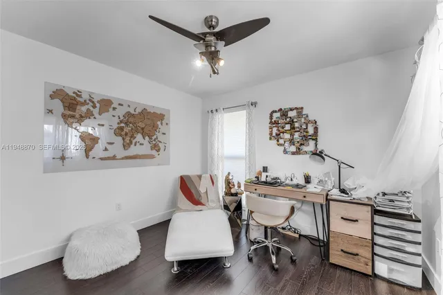 a view of a workspace with furniture and wooden floor