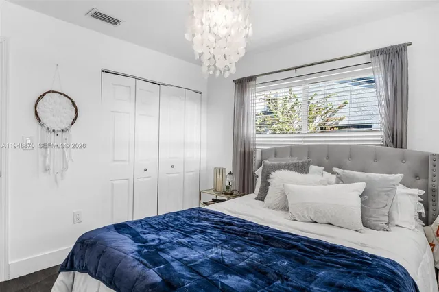 a bedroom with a bed and a large window