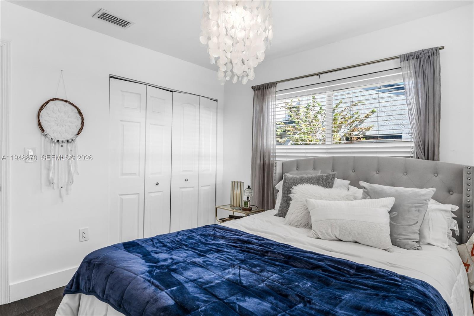 12210 Southwest 92nd Street Miami, FL 33186 - Photo 15 of 38 a bedroom with a bed and a large window
