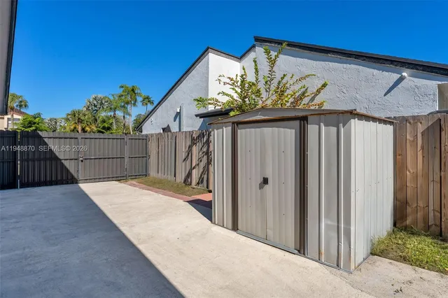 a front view of a house with a garden and patio