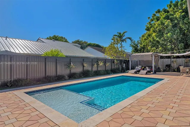 a house with swimming pool in front of it