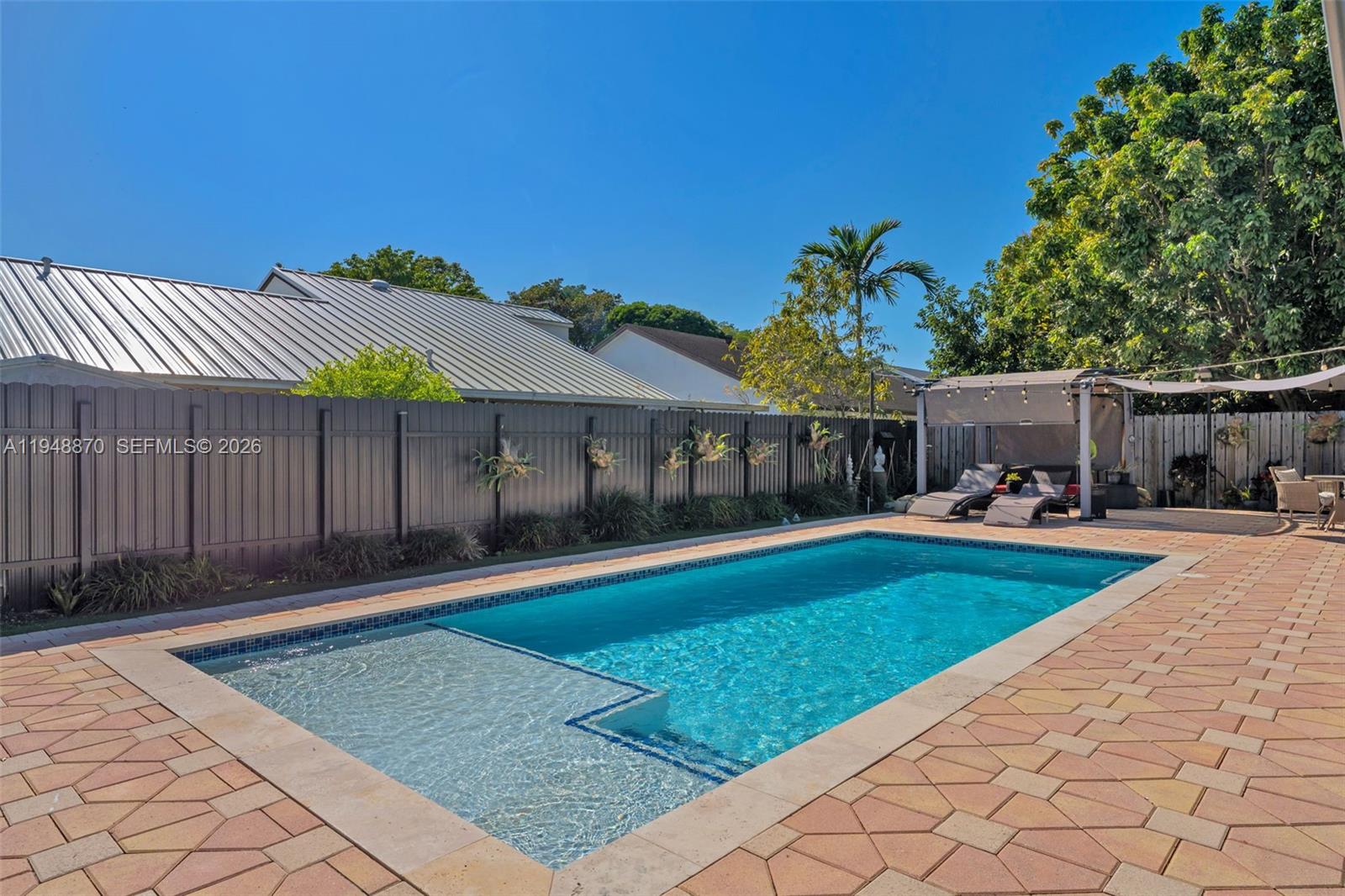 12210 Southwest 92nd Street Miami, FL 33186 - Photo 19 of 38 a front view of a house with a garden and patio