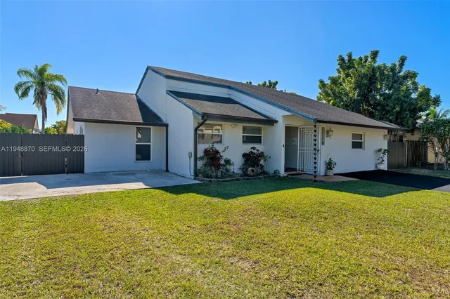 a view of a house with swimming pool and a yard