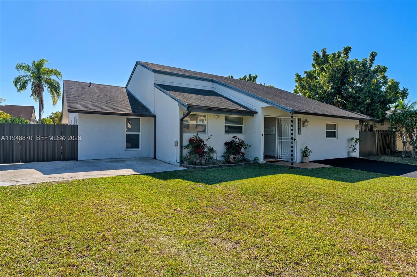 12210 Southwest 92nd Street Miami, FL 33186 - Photo 2 of 38 a view of a house with swimming pool and a yard