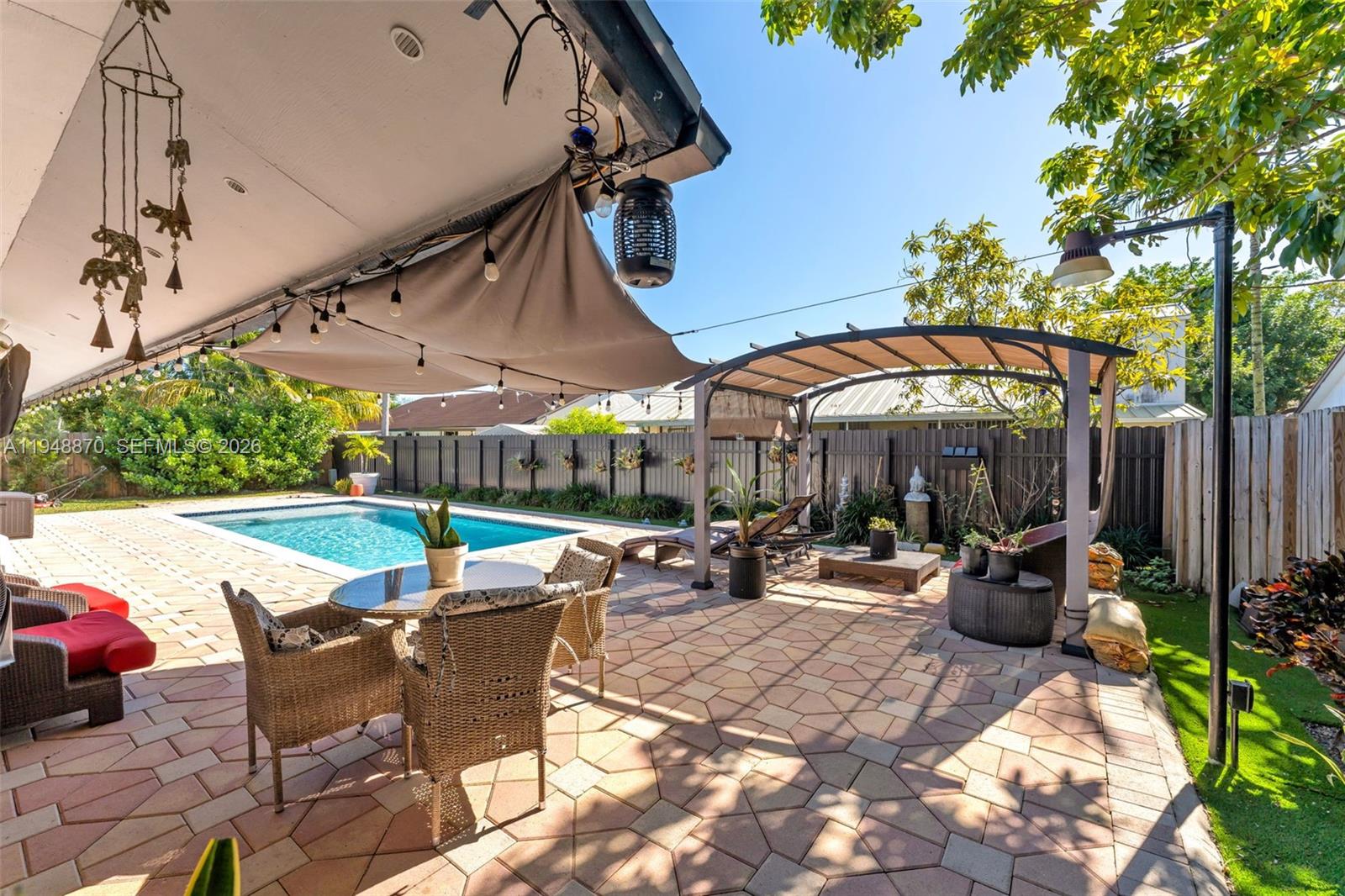 12210 Southwest 92nd Street Miami, FL 33186 - Photo 22 of 38 a view of a patio with a table and chairs under an umbrella