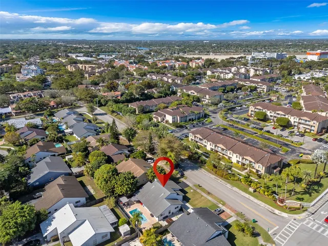 an aerial view of residential houses with outdoor space