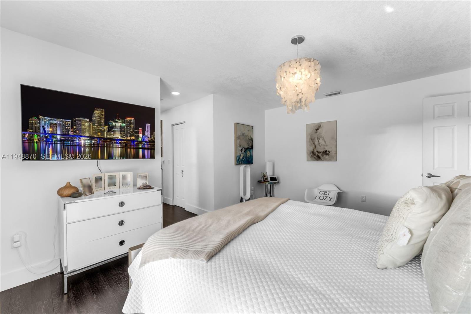12210 Southwest 92nd Street Miami, FL 33186 - Photo 8 of 38 a bedroom with a bed and a chandelier
