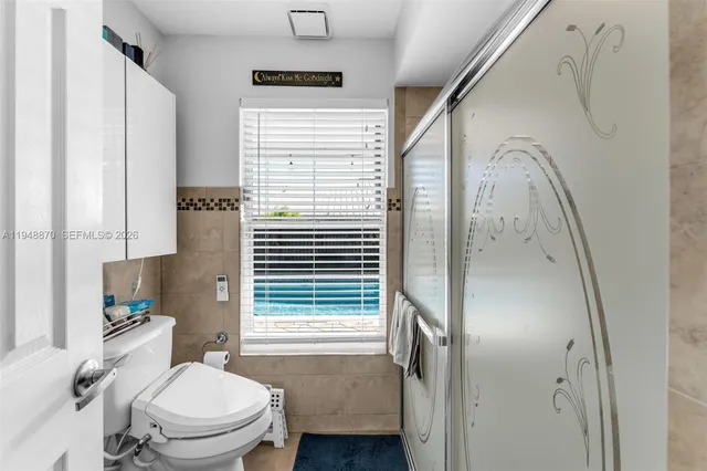 a bathroom with a toilet a sink and a shower