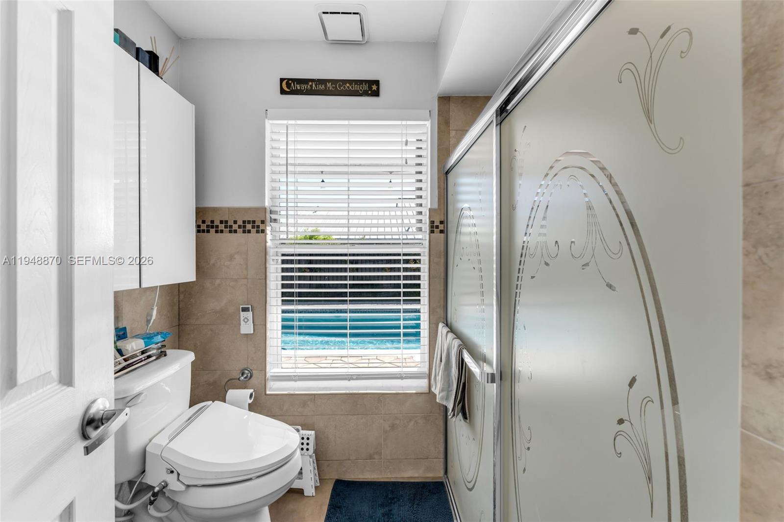 12210 Southwest 92nd Street Miami, FL 33186 - Photo 10 of 38 a bathroom with a toilet a sink and a shower