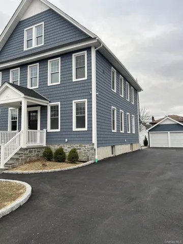 a front view of a house with a garden