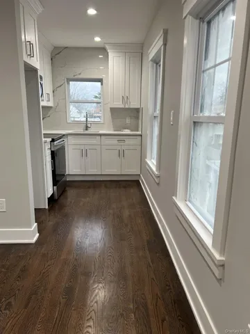 a kitchen with a refrigerator a sink and cabinets