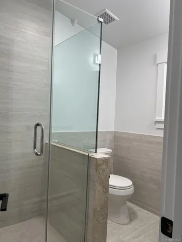 a bathroom with a toilet a sink and shower