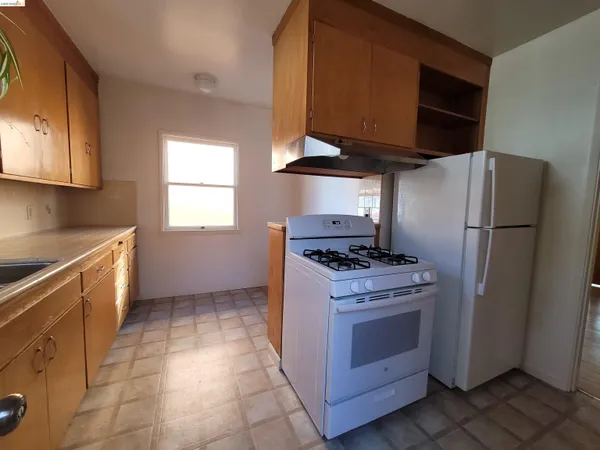 a kitchen with sink stove and cabinets