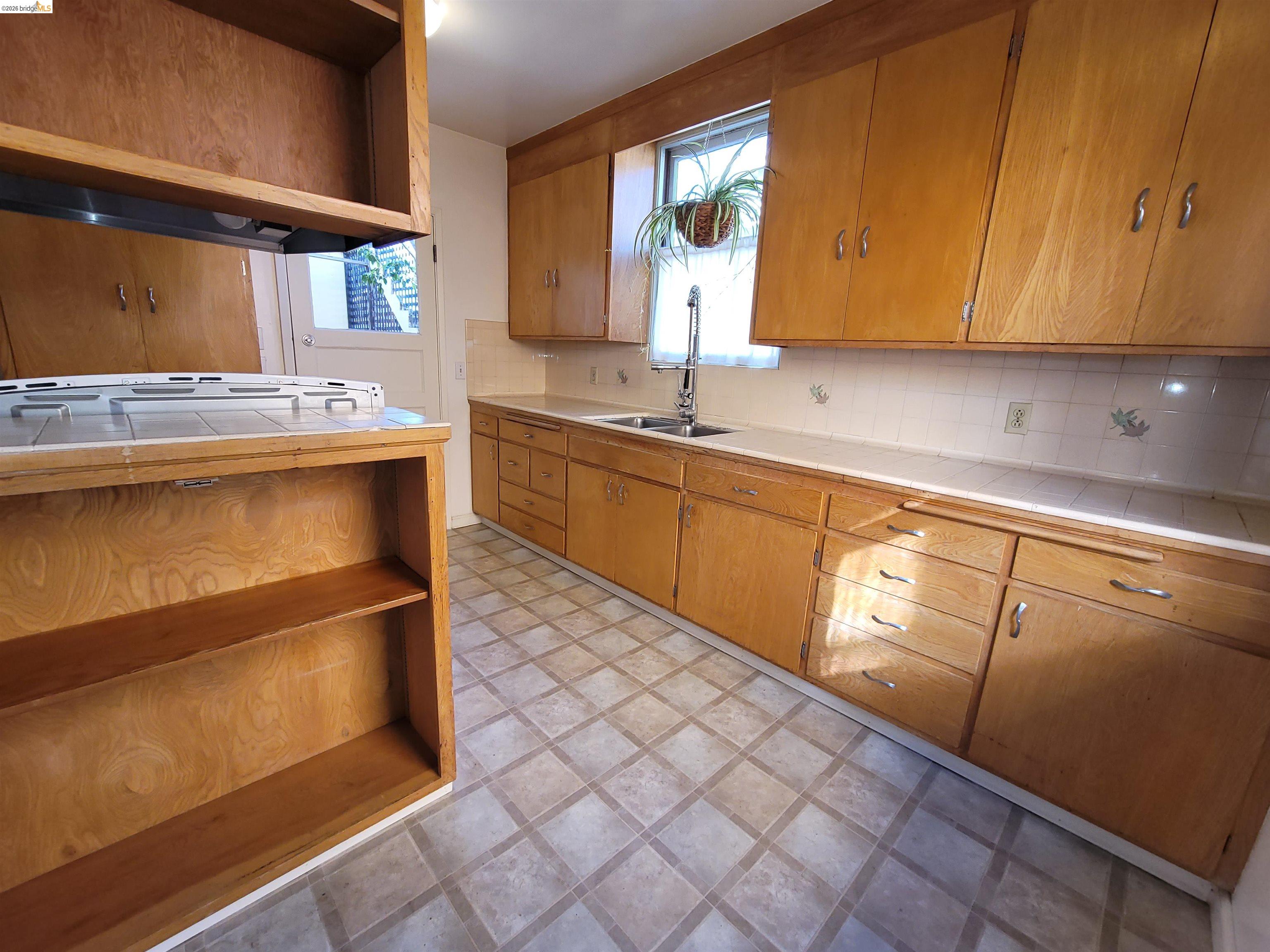 1901 Parker Street, Unit 3 Berkeley, CA 94704 - Photo 20 of 27 a kitchen with stainless steel appliances granite countertop a sink and cabinets