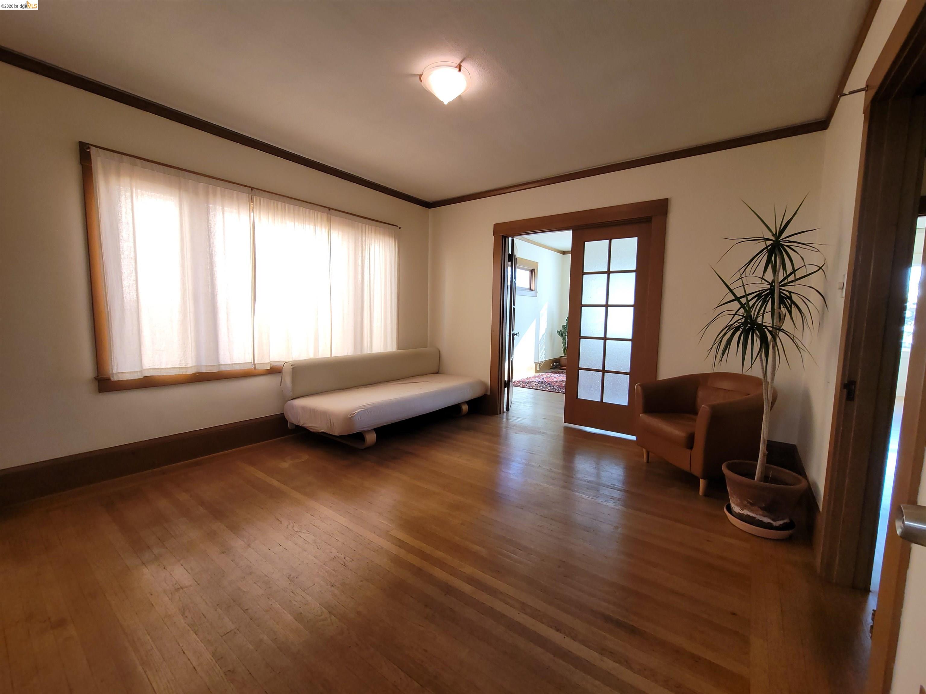 1901 Parker Street, Unit 3 Berkeley, CA 94704 - Photo 9 of 27 a living room with furniture and a large window