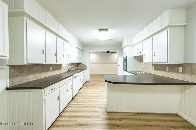 a kitchen with stainless steel appliances granite countertop a sink and a stove