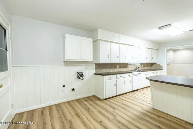 a kitchen with granite countertop white cabinets and white appliances