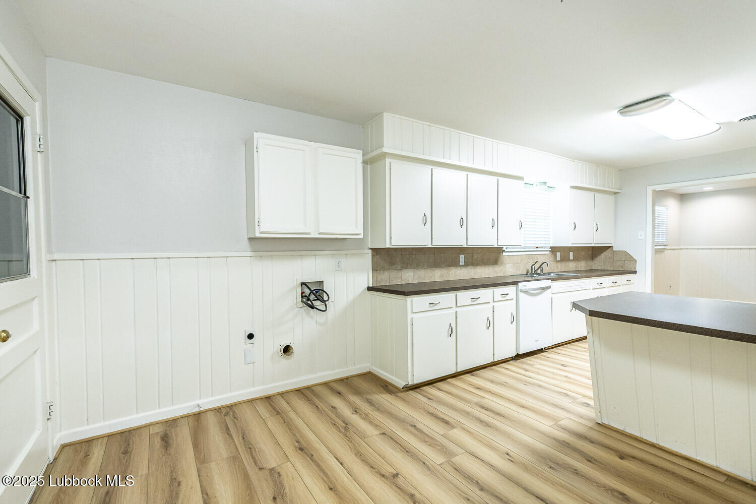 2601 33rd Street Lubbock, TX 79410 - Photo 14 of 30 a kitchen with granite countertop white cabinets and white appliances