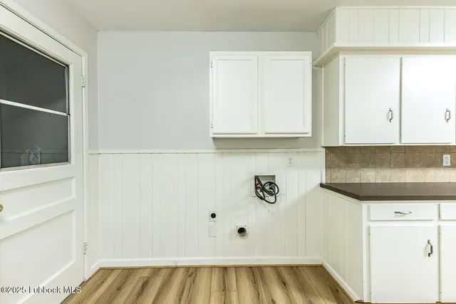 a view of kitchen with microwave and cabinets