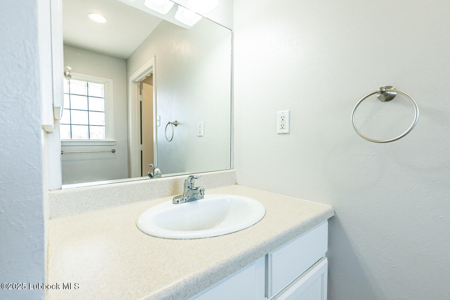 2601 33rd Street Lubbock, TX 79410 - Photo 20 of 30 a bathroom with a sink and a mirror