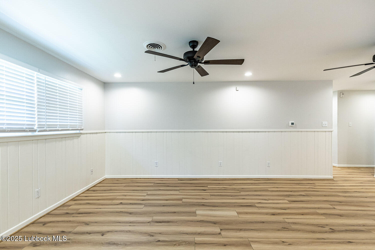 2601 33rd Street Lubbock, TX 79410 - Photo 8 of 30 a view of a room with an empty space & wooden floor