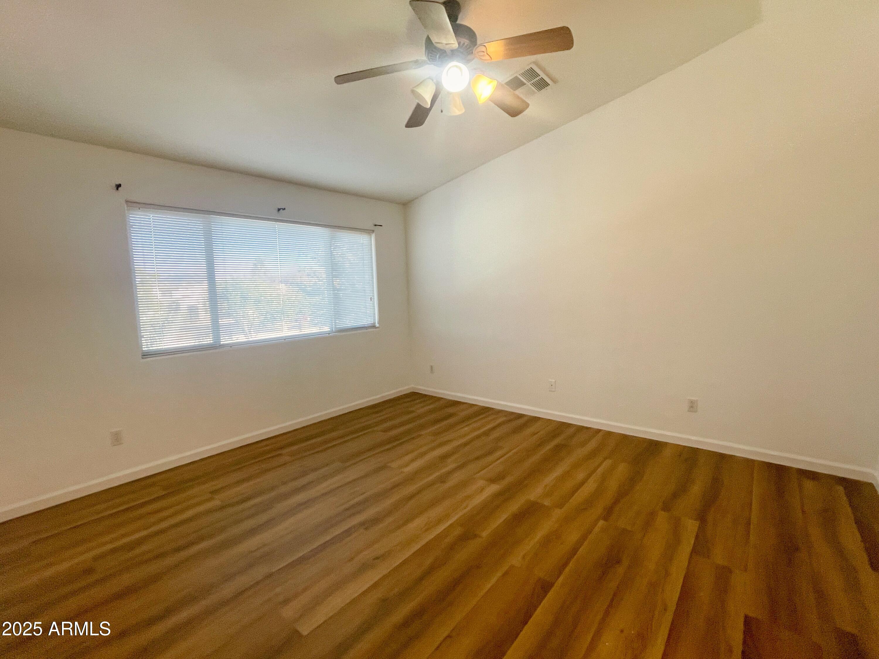 2211 South Harper Mesa, AZ 85209 - Photo 12 of 27 a view of empty room with wooden floor and fan