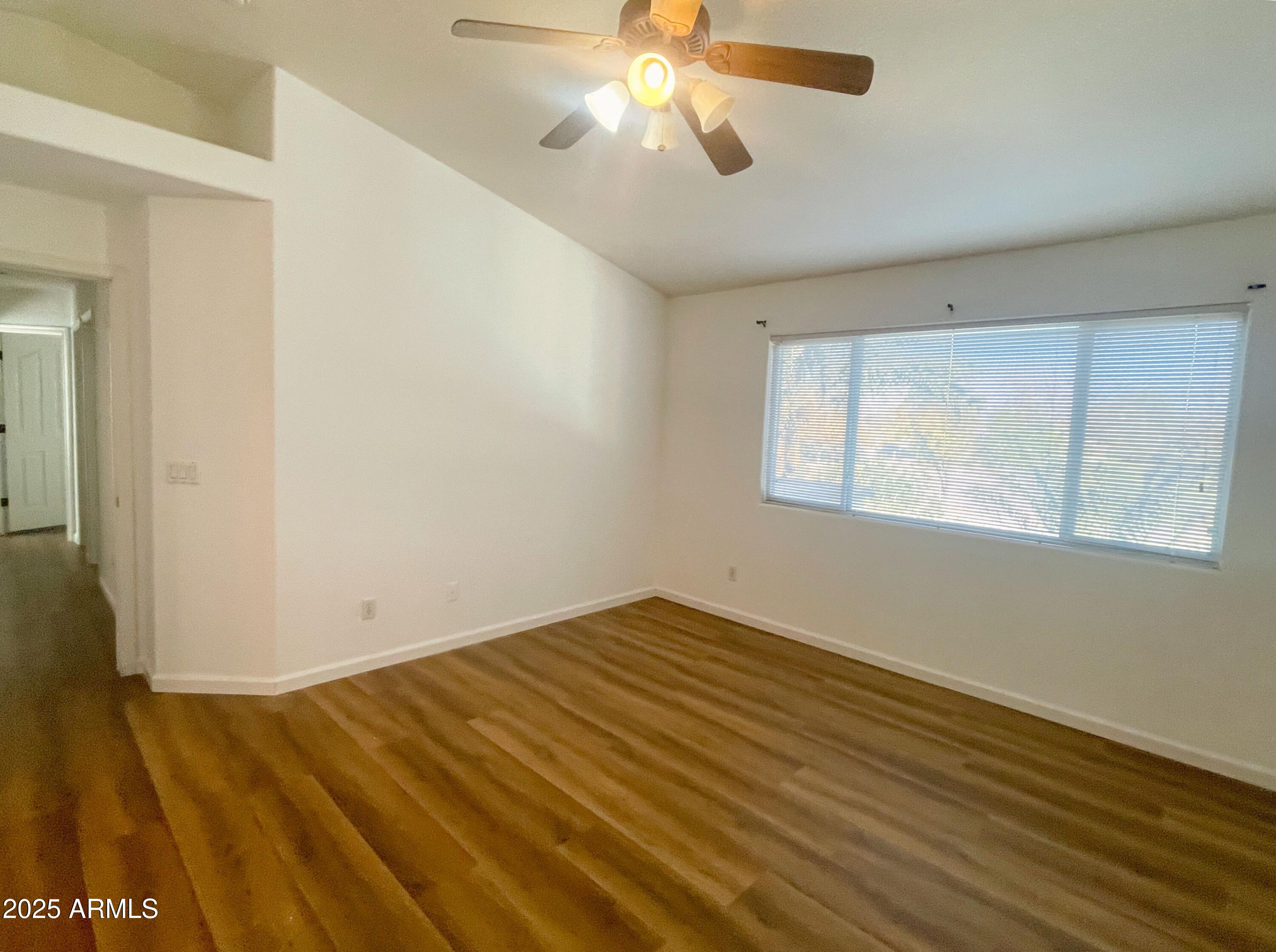 2211 South Harper Mesa, AZ 85209 - Photo 14 of 27 a view of an empty room with wooden floor and a window