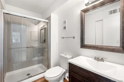 a bathroom with a sink toilet and shower