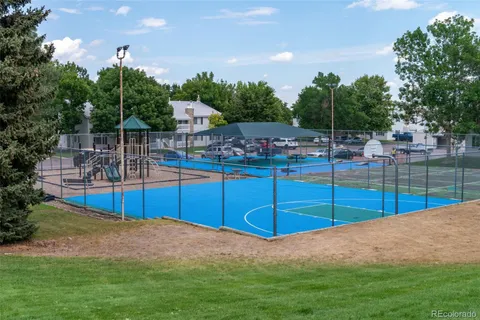 a swimming pool with outdoor seating and trees