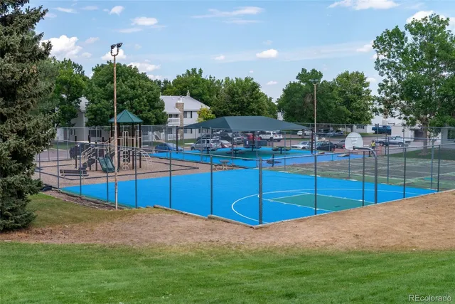 a swimming pool with outdoor seating and trees