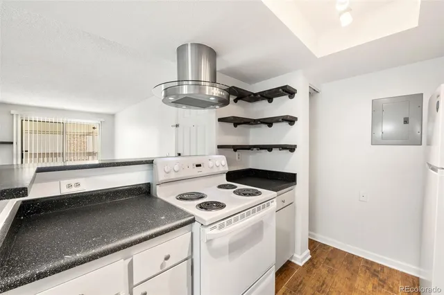 a kitchen with a stove and white cabinets