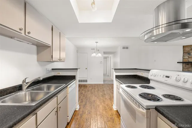 a kitchen that has a sink and a stove