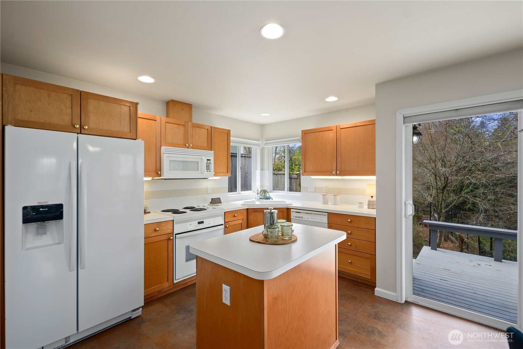 17421 95th Place Southwest Vashon, WA 98070 - Photo 12 of 32 a kitchen with a refrigerator a sink and a stove top oven
