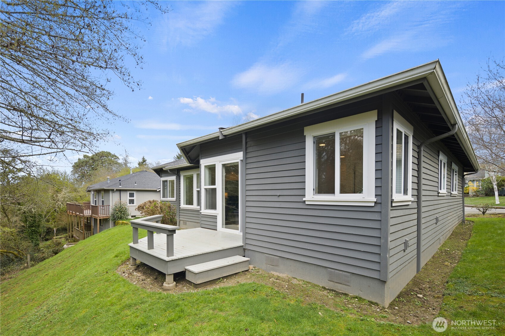 17421 95th Place Southwest Vashon, WA 98070 - Photo 26 of 32 a white house that has a small yard next to a yard