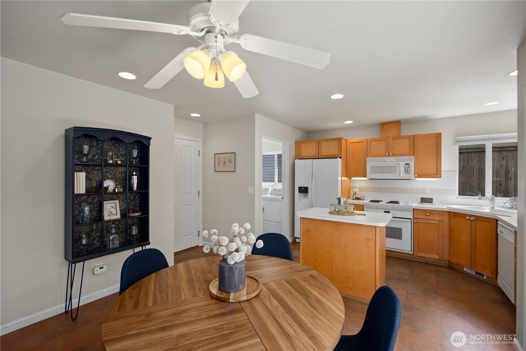 17421 95th Place Southwest Vashon, WA 98070 - Photo 9 of 32 a kitchen with a dining table chairs stainless steel appliances and cabinets