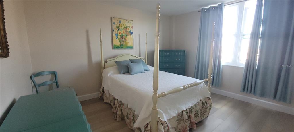 632 Edgewater Drive, Unit 235 Dunedin, FL 34698 - Photo 14 of 37 a bed sitting in a bedroom next to a window