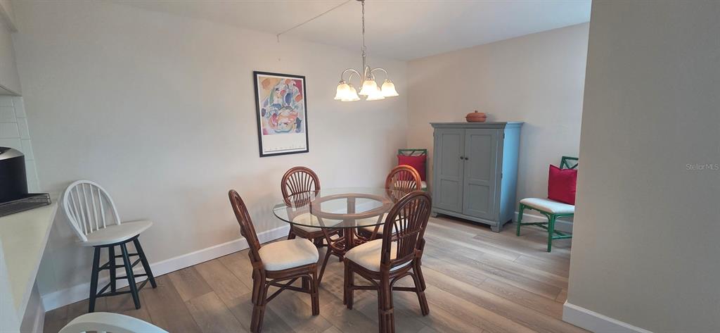 632 Edgewater Drive, Unit 235 Dunedin, FL 34698 - Photo 15 of 37 a view of a dining room with furniture and wooden floor