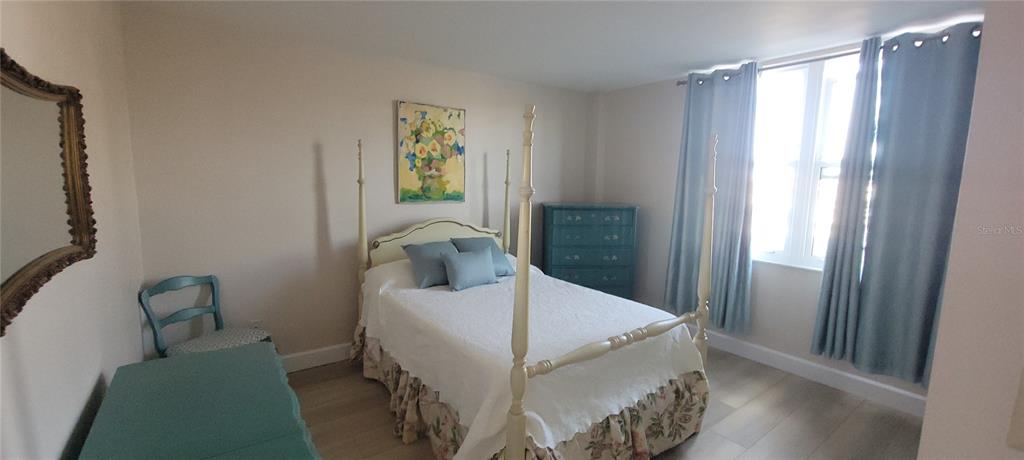 632 Edgewater Drive, Unit 235 Dunedin, FL 34698 - Photo 17 of 37 a bedroom with a bed and a window