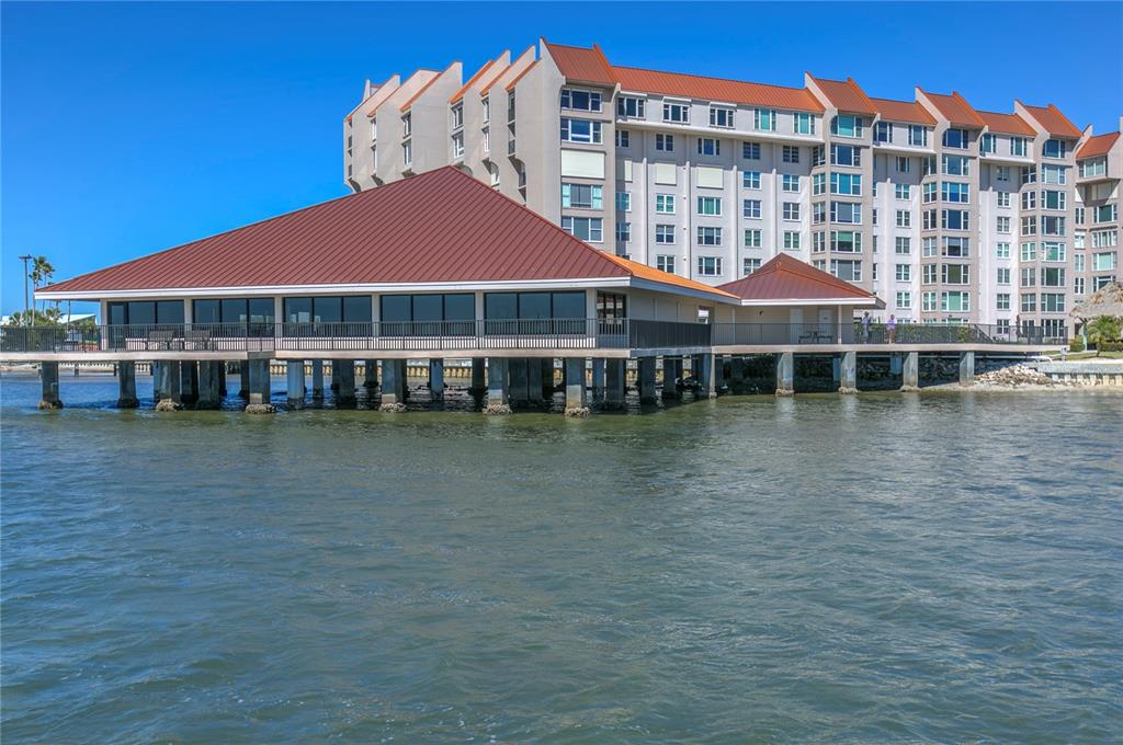 632 Edgewater Drive, Unit 235 Dunedin, FL 34698 - Photo 2 of 37 a front view of a building with a lake view