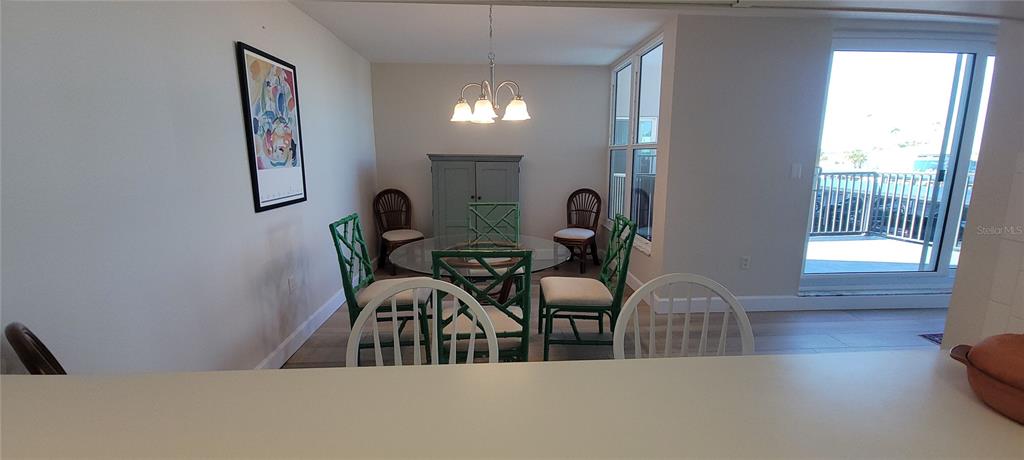 632 Edgewater Drive, Unit 235 Dunedin, FL 34698 - Photo 24 of 37 a view of a dining room with furniture and wooden floor