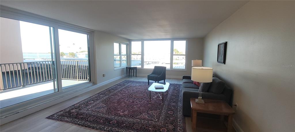 632 Edgewater Drive, Unit 235 Dunedin, FL 34698 - Photo 25 of 37 a living room with furniture and wooden floor