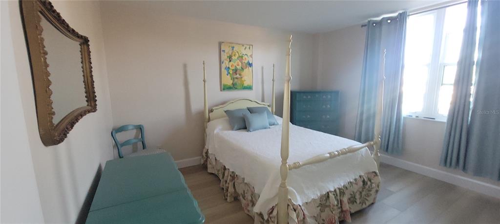 632 Edgewater Drive, Unit 235 Dunedin, FL 34698 - Photo 27 of 37 a bedroom with a bed and a window