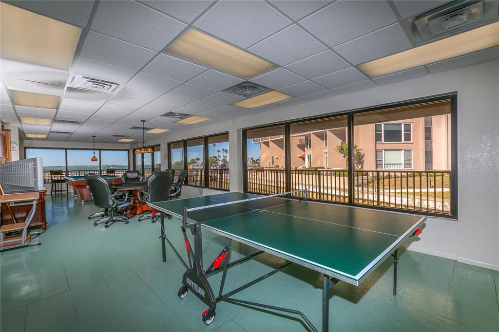 632 Edgewater Drive, Unit 235 Dunedin, FL 34698 - Photo 29 of 37 a room with gym equipment pool table and chairs